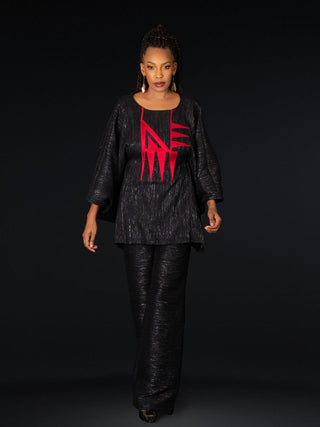Model wearing Alia Bare black top with red embroidery and wide sleeves