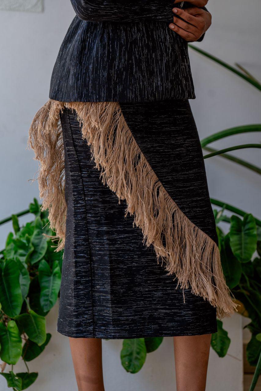 Front view of Alia Bare woven black skirt with raffia fringe on model