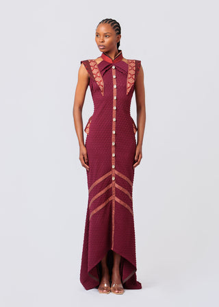 Woman wearing a Maroon dress with intricate designs on a white background