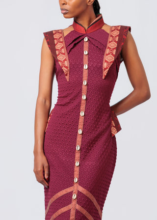 Woman wearing a maroon dress with red patterns and buttons on a light gray background available at House of NALA 