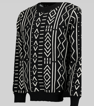 Black and white African print knit sweater with a boxy fit and long sleeves. This view showcases the drape and flow of the sweater.