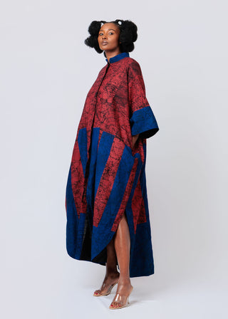 Woman wearing a burgundy and blue patterned shirt dress on a white background