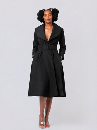 Woman wearing a black coat on a white background