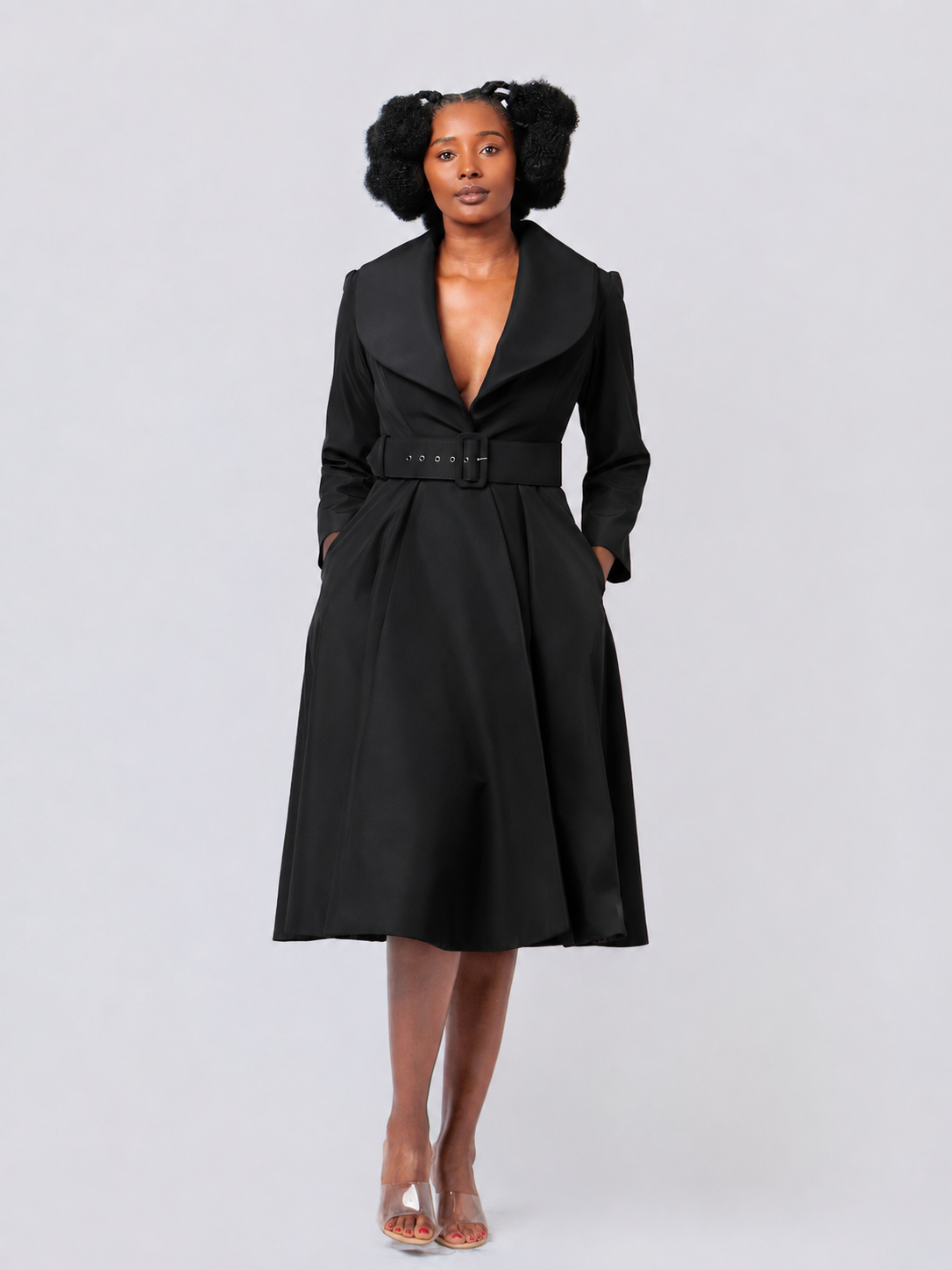 Woman wearing a black coat on a white background
