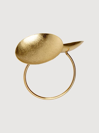 Gold ring with a unique design on a light gray background