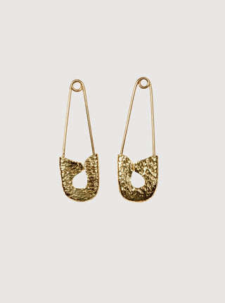 Pair of gold earrings on a light gray background