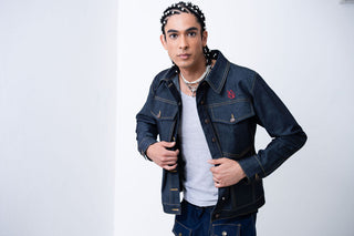 Man wearing a denim jacket with a brand logo on a white background