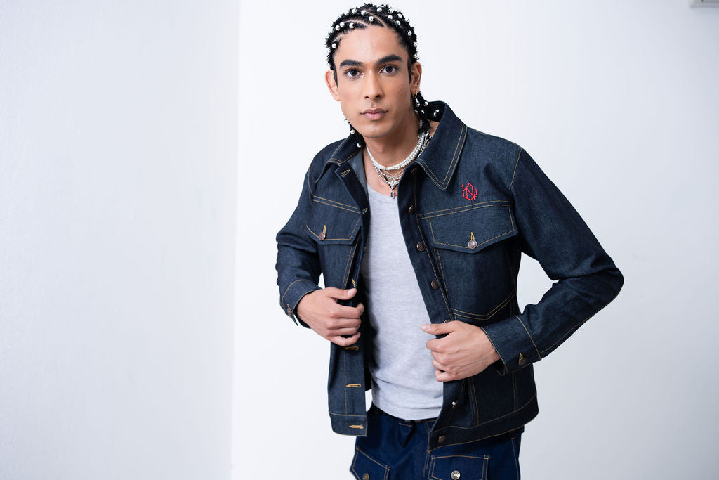 Man wearing a denim jacket with a brand logo on a white background