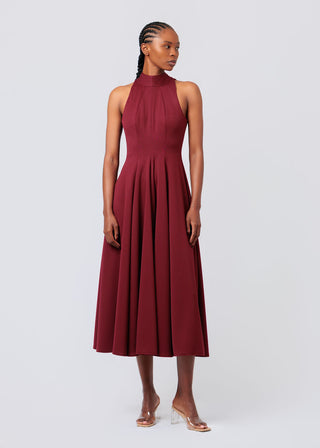 Woman wearing a burgundy dress on a white background