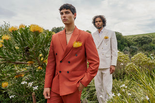 Two men in suits standing in a field with flowers. South African Fashion. House of Nala Contemporary African Luxury Fashion
