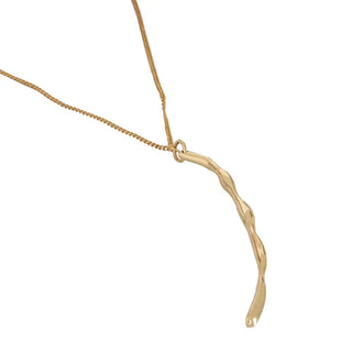 Gold necklace with a unique pendant on a white background