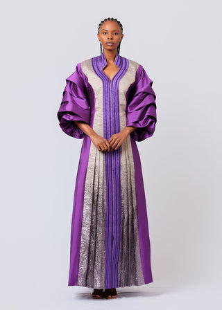 Model wearing a purple and gray traditional outfit on a white background