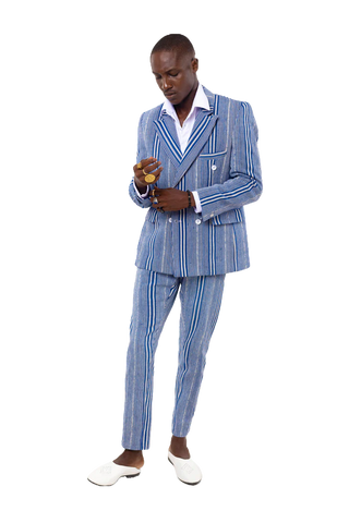 Man wearing a blue striped suit holding a drink on a white background