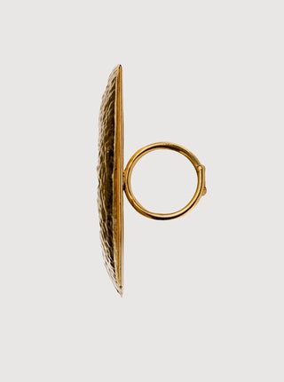 Gold hoop earring with textured design on a light gray background