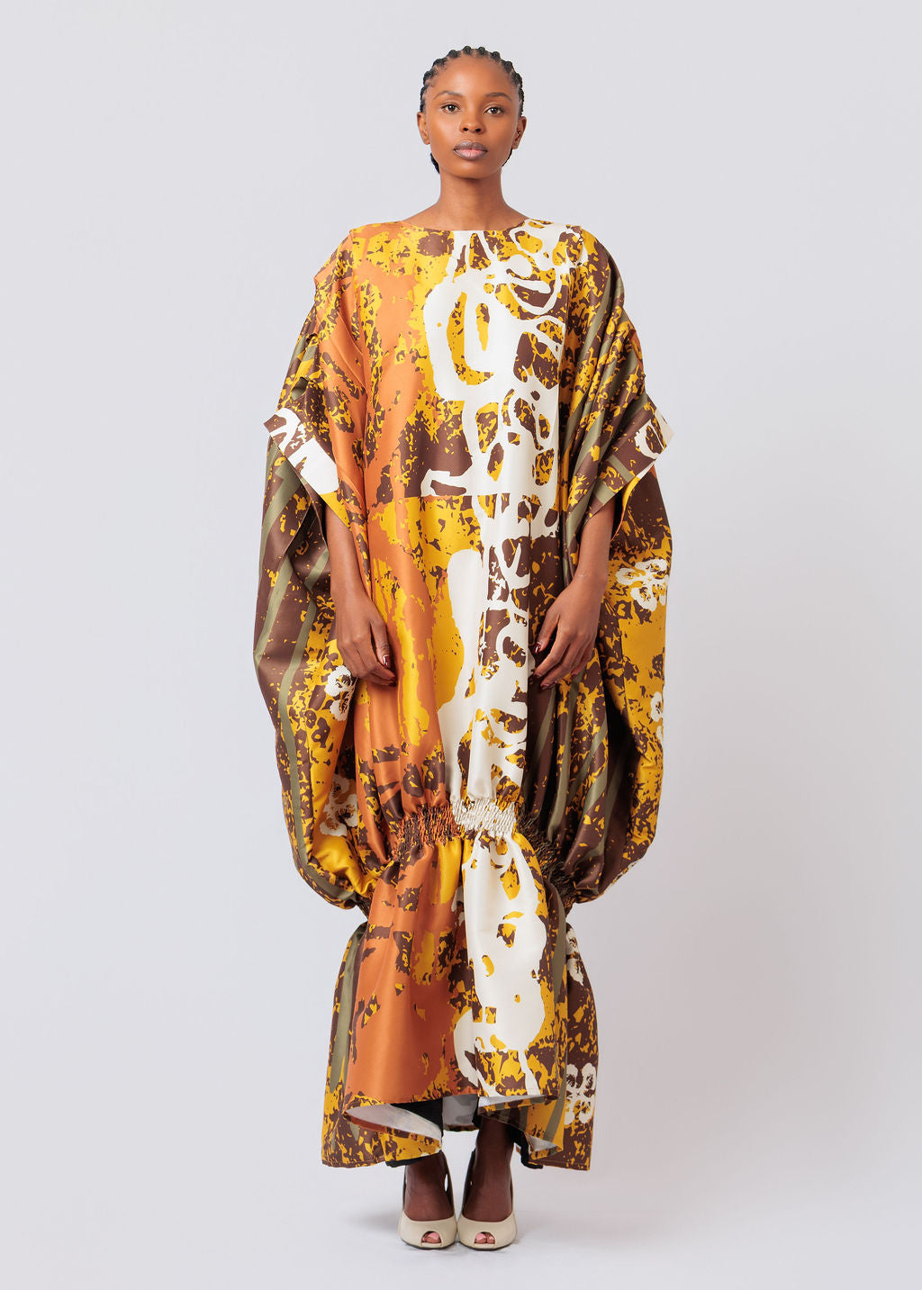 Woman wearing a colorful patterned dress on a white background
