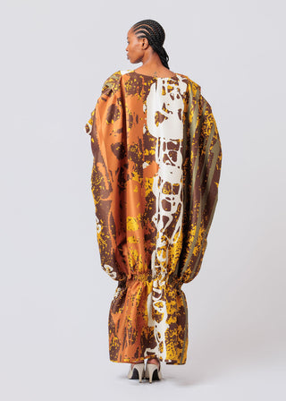Woman wearing a patterned dress with a white background