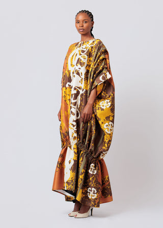 Woman wearing a patterned Mali Jite Maxi Dress on a white background