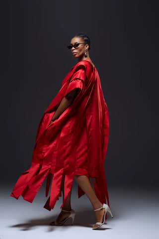 Model wearing red flowy dress back 