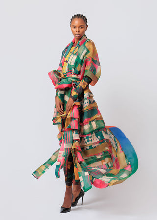 Woman wearing a colorful, patterned Mantsho Organza River Kimono against a white background