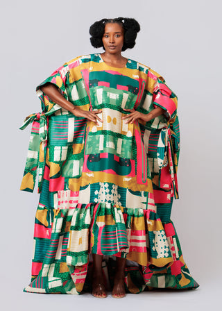 Woman wearing a colorful patterned dress with a plain background