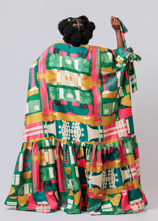 Woman wearing a colorful geometric patterned dress on a plain background available at the House of NALA