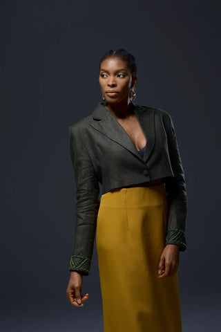 Model wearing NALAPrive_Cropped Green Beaded wrist Jacket with a yellow mustard skirt