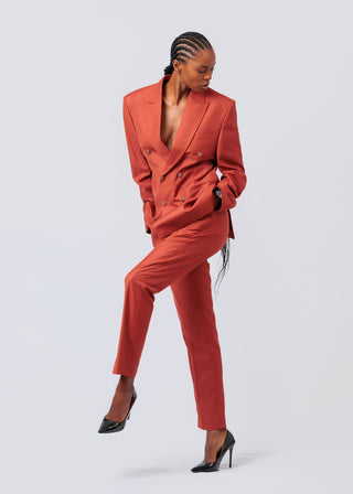 Woman wearing a orange suit on a white background