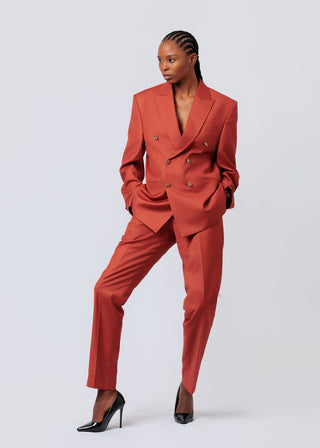 Woman wearing a orange suit on a white background