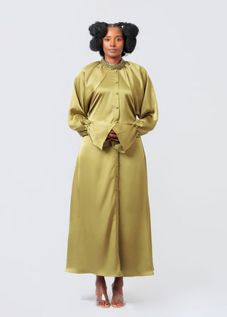 Woman wearing a long Olive Green Kimono Dress with a high collar on a white background