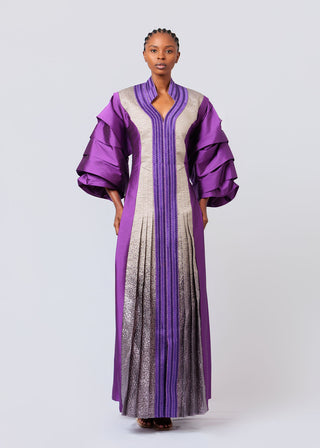 Woman wearing a purple and gray gradient dress on a white background