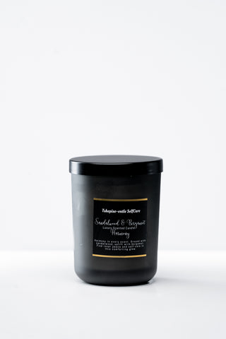 Black candle with a label on a white background