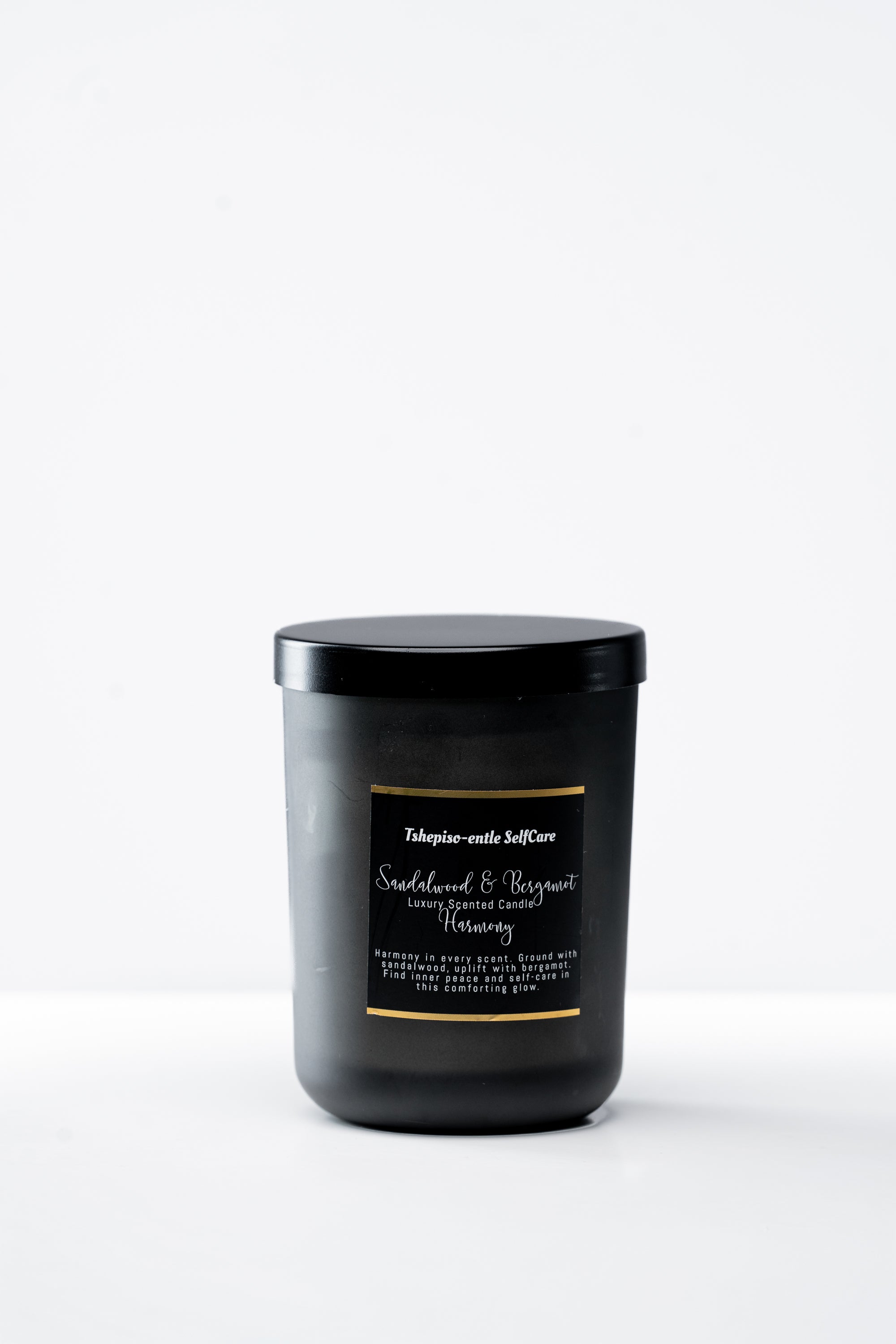 Black candle with a label on a white background