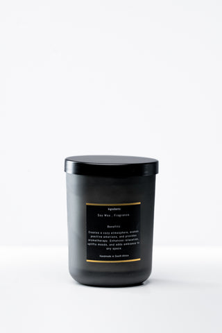 Black candle with a label on a white background
