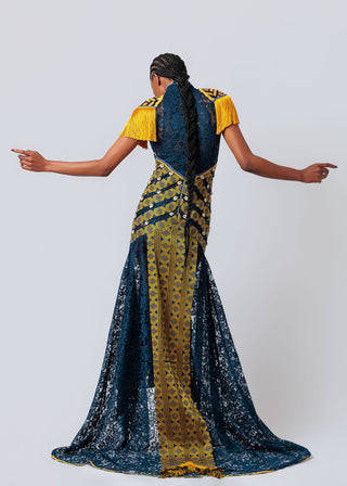 Woman wearing a blue and yellow patterned dress against a white background