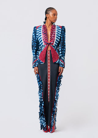 Woman wearing a colorful, patterned outfit on a white background