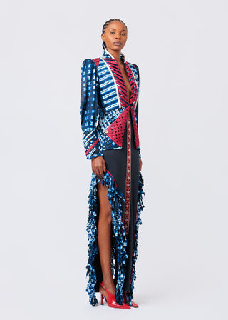 Woman wearing a colorful patterned dress with a high slit on a white background available at House of NALA