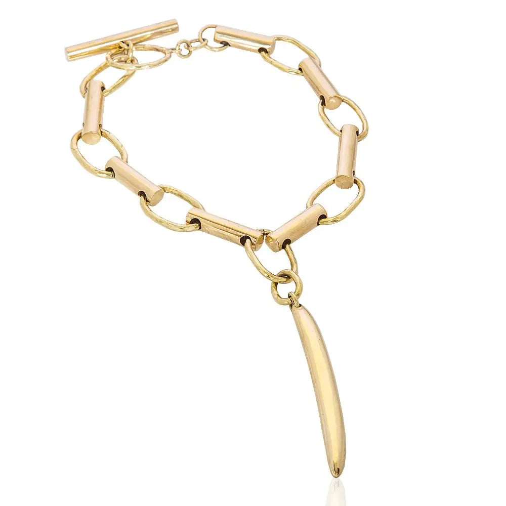 Gold chain bracelet with a unique pendant on a white background