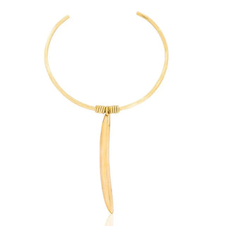 Gold necklace with a long, thin pendant on a white background