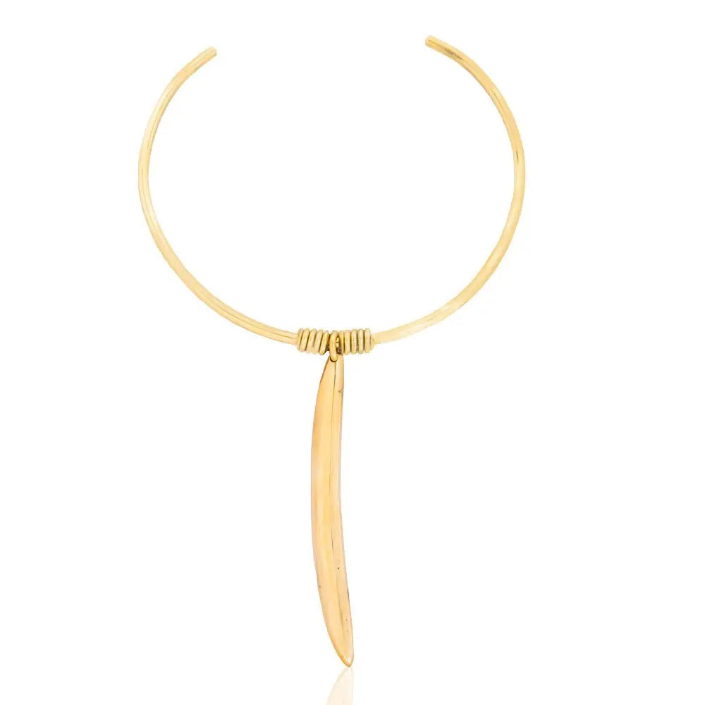 Gold necklace with a long, thin pendant on a white background